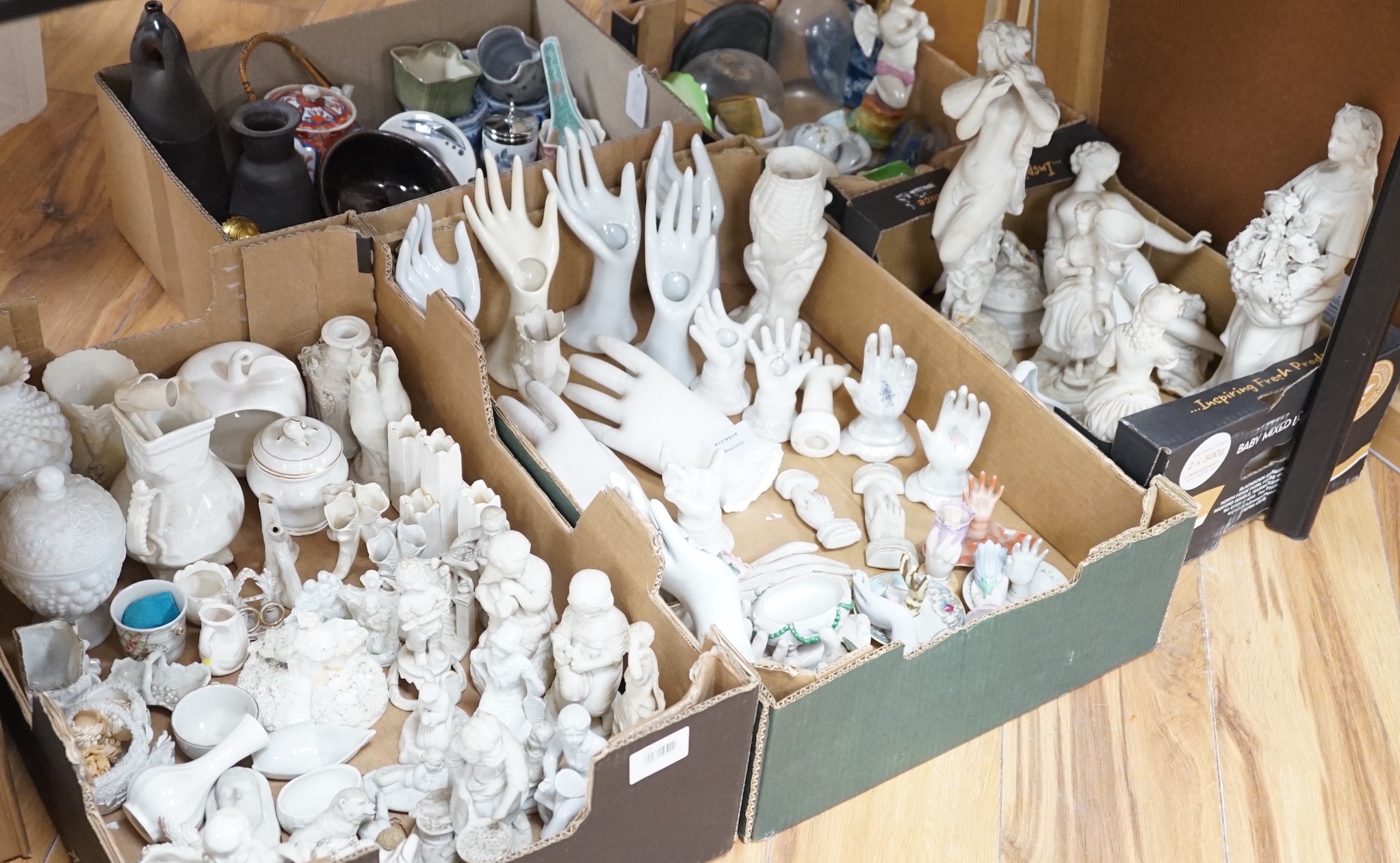 A large collection of mostly 19th century white glazed ceramics, including ring trees, model hands, figurines, vases and other coloured ceramics (five boxes)